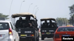 Security forces drive towards Grand Bassam in Abidjan, Ivory Coast, March 13, 2016. 