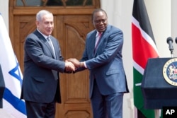 FILE - Israeli Prime Minister Benjamin Netanyahu, left, and Kenyan President Uhuru Kenyatta shake hands at State House in Nairobi, Kenya, July 5, 2016.