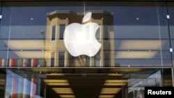 FILE - The Apple logo is pictured on the front of a retail store in San Francisco, Apr. 23, 2014. In a statement, Apple officials said "we strongly believe that transgender students should be treated as equals."