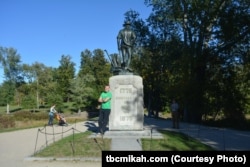 Mikah Meyer poses next to The Minute Man statue created by Daniel Chester French in 1875. The statue was made from seven Civil War cannons donated for the project by Congress.