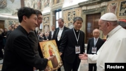 Pope Francis receives a gift during a special audience with participants in a conference titled "Perspectives for a World Free from Nuclear Weapons and for Integral Disarmament" at the Vatican, Nov. 10, 2017. 