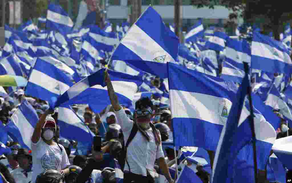 Demonstrators protesting government repression wave Nicaraguan flags in Managua, May 9, 2018.