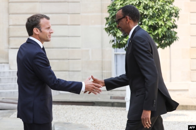 FILE - France's President Emmanuel Macron, left, welcomes Rwanda's President Paul Kagame upon his arrival at the Elysee presidential palace in Paris, May 23, 2018.