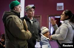 FILE - Migrants attend a workshop for legal advice held by the Familia Latina Unida and Centro Sin Fronteras at Lincoln United Methodist Church in south Chicago, Illinois, Jan. 10, 2016.