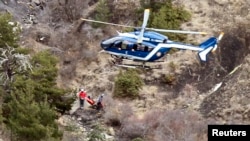 A French gendarme helicopter flies over the crash site of an Airbus A320, near Seyne-les-Alpes, March 25, 2015. French investigators will sift through wreckage on Wednesday for clues into why a German Airbus operated by Lufthansa's Germanwings budget airline plowed into an Alpine mountainside, killing all 150 people on board. REUTERS/Emmanuel Foudrot 