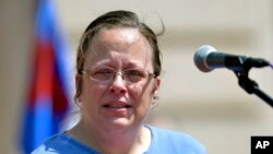 FILE - Rowan County Kentucky clerk Kim Davis speaks to a gathering of supporters during a rally on the steps of the Kentucky State Capitol in Frankfort Ky., Aug. 22, 2015.