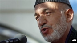 Afghan President Hamid Karzai speaks to the media after offering the Eid al-Adha's prayers at the presidential palace in Kabul, Afghanistan, 16 Nov. 2010.