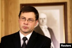 FILE - Valdis Dombrovskis, then Latvia's prime minister, speaks during a news conference in Riga, Nov. 27, 2013. He is now a European Commission vice president.