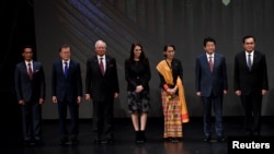 FILE - Japan's Prime Minister Shinzo Abe stands for photo with fellow Southeast Asian leaders at the 31st ASEAN Summit, in Manila, Philippines, Nov. 13, 2017. 