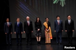FILE - Japan's Prime Minister Shinzo Abe (2-R) stands for a photo with fellow Southeast Asian leaders at the 31st ASEAN Summit, in Manila, Philippines, Nov. 13, 2017.
