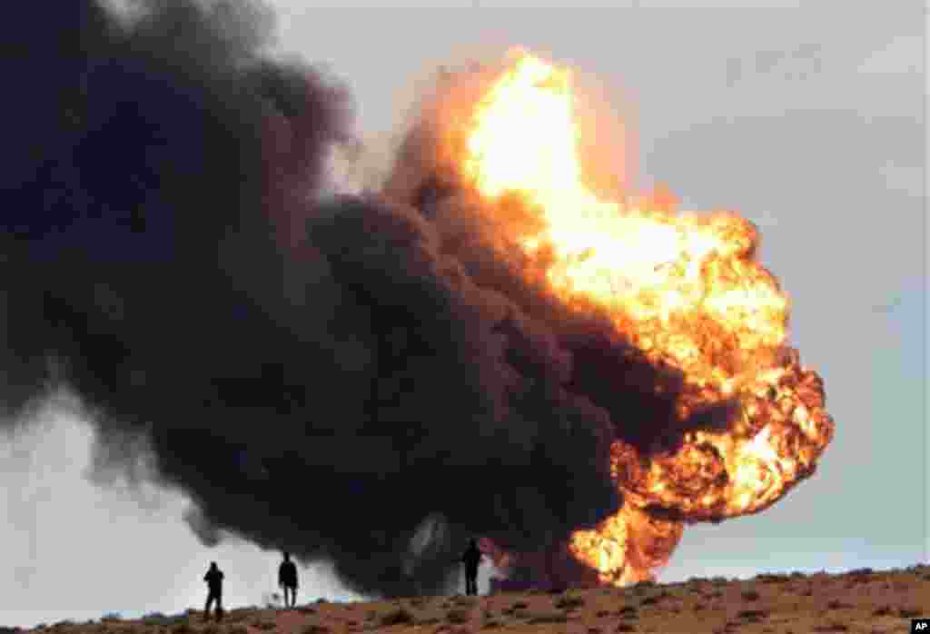A fuel storage depot, burns after being struck during fighting between rebels and pro-Moammar Gadhafi forces, in Sedra, eastern Libya, March 9, 2011.