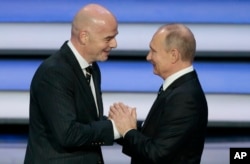 FIFA president Gianni Infantino, left, and Russian President Vladimir Putin shakes hands at the 2018 soccer World Cup draw in the Kremlin in Moscow, Dec. 1, 2017.