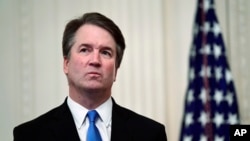 FILE - U.S. Supreme Court Justice Brett Kavanaugh stands before his ceremonial swearing-in in the East Room of the White House in Washington, Oct. 8, 2018.