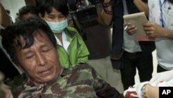 An injured Thai soldier is treated on his arrival at Kantharalak, hospital in Si Sa ket Province, Thailand Sunday, Feb. 6, 2011