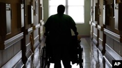 FILE - A patient is assisted at Southeastern Regional Medical Center in Lumberton, North Carolina, July 10, 2014. Nationwide, 81 of the more than 1,800 rural hospitals in America have closed since 2010.