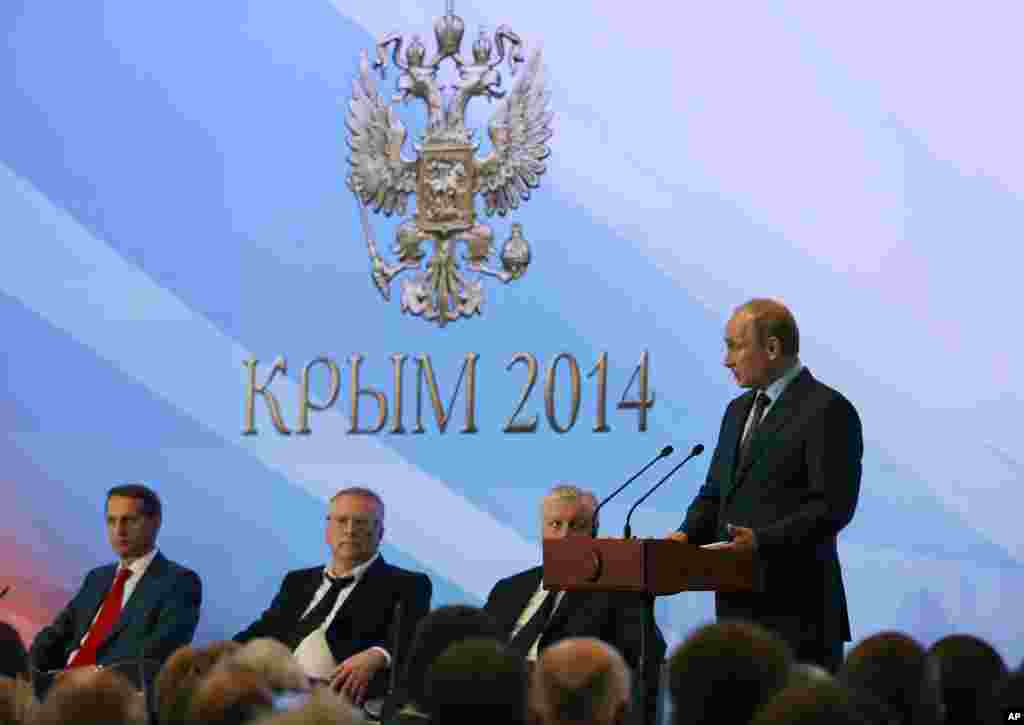 President Vladimir Putin addresses members of Crimea parliament. While in a meeting with lawmakers he commented that his country was doing "all we can to stop bloodshed in Ukraine as soon as possible," about 30 km from Yalta, Crimea. Aug. 14, 2014.