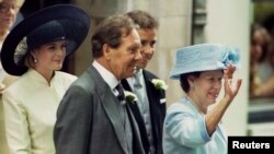 FILE - Lord Snowdon (C) and his then former wife, Princess Margeret (R), are seen leaving St. Stephen Walbrook church in London, July 14, 1994, following the wedding of their daughter, Lady Sarah Armstrong Jones (not pictured).