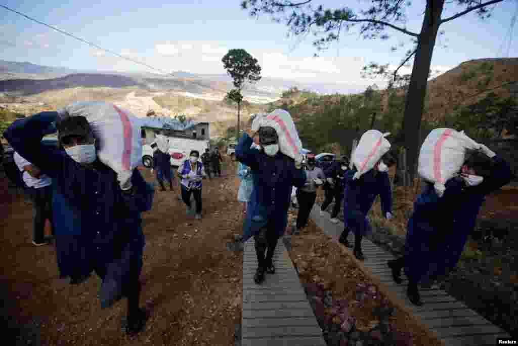 Soldiers carry bags of groceries to be delivered to residents in Los Pinos neighborhood, as part of the measures against the spread of the coronavirus disease (COVID-19), in Tegucigalpa, Honduras.