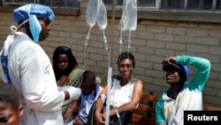 Patients await treatment at a makeshift cholera clinic in Harare, Zimbabwe, Sept. 11, 2018.