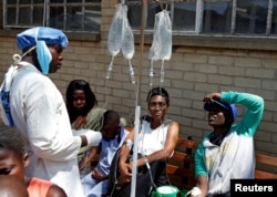 FILE - Patients await treatment at a makeshift cholera clinic in Harare, Zimbabwe, Sept. 11, 2018.