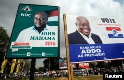 FILE - Campaign billboard show John Mahama, at the time Ghana's president and National Democratic Congress presidential candidate, and the opposition New Patriotic Party presidential candidate, Nana Akufo-Addo, on a street in Accra, Dec. 3, 2016. Akufo-Addo defeated Mahama by a million votes.