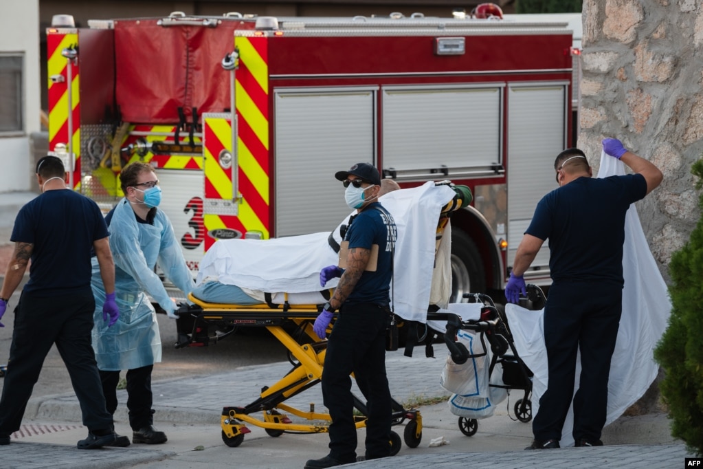 EMS workers pick up a suspected COVID-19 positive patient in the Rio Grande Historic District of El Paso, Texas on November 15, 2020.
