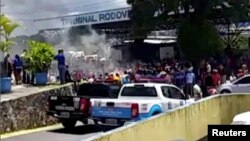 People look at a demostration at the interstate bus terminal in Pacaraima, Brazil, Aug. 18, 2018 in this still image obtained from a social media video. 
