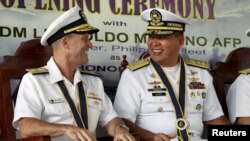 Philippine Navy Rear Admiral Leopoldo Alano (R) shares a light moment with U.S. Navy Rear Admiral William Merz during the opening ceremony of the Cooperation Afloat Readiness and Training (CARAT) 2015 at navy headquarters in Puerto Princesa city, Palawan