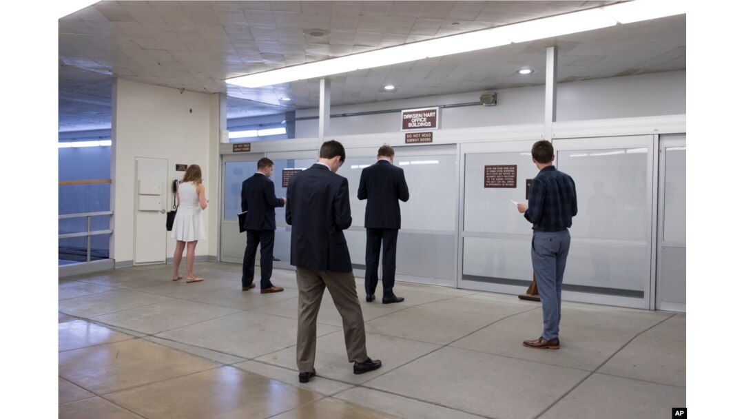 Congressional aides and interns wait for a tram as corridors around the Senate are quiet after lawmakers departed Capitol Hill in Washington for the Independence Day recess, June 30, 2017. The Republican leadership in the Senate decided this week to delay a vote on their long-awaited health care bill in following opposition in the GOP ranks.
