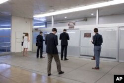 Congressional aides and interns wait for a tram as corridors around the Senate are quiet after lawmakers departed Capitol Hill in Washington for the Independence Day recess, June 30, 2017. The Republican leadership in the Senate decided this week to delay a vote on their long-awaited health care bill in following opposition in the GOP ranks.
