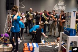 Syracuse Junior High School Mesa Club from Syracuse, Utah shows how their machine "A Day in the Life of a Student" completes the task of applying a BAND-AID bandage at the Rube Goldberg Machine Contest, 2017.