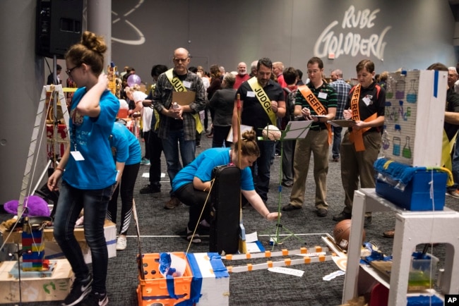 Syracuse Junior High School Mesa Club from Syracuse, Utah shows how their machine "A Day in the Life of a Student" completes the task of applying a BAND-AID bandage at the Rube Goldberg Machine Contest, 2017.