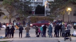 A red SUV speeds past attendees moments before plowing into a crowd at a Christmas parade in Waukesha, Wisconsin, U.S., in this still image taken from a Nov. 21, 2021 social media video.