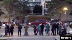 A red SUV speeds past attendees moments before plowing into a crowd at a Christmas parade in Waukesha, Wisconsin, U.S., in this still image taken from a Nov. 21, 2021 social media video.
