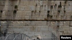 A stone that fell off the Western Wall in Jerusalem can be seen near the wall in Jerusalem's Old City, July 23, 2018. 