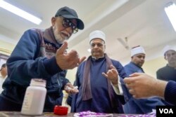 Voters dye their fingers with pink ink after casting their ballots to prevent voter-fraud in Cairo on April 20, 2019.