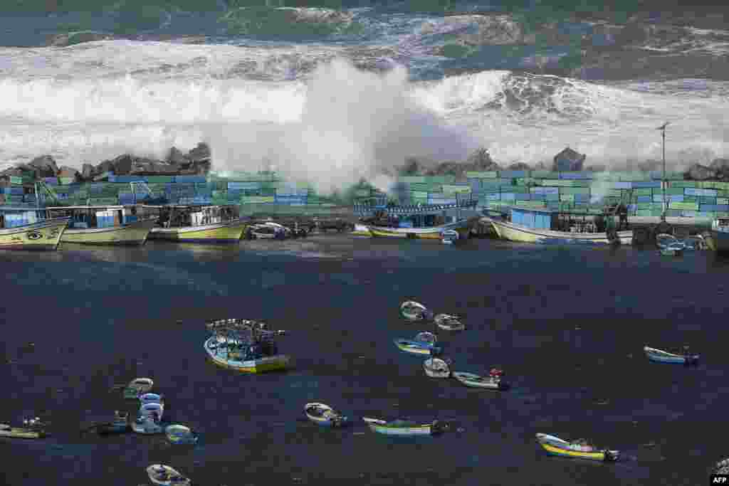 Waves break on the sea port in Gaza City during a storm.