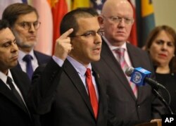 Venezuela Foreign Affairs Minister Jorge Arreaza, speaks during a press conference, is surrounded by supporting diplomats from 16 countries including Russia, China, Iran and Syria, at U.N. headquarters, Feb. 14, 2019.