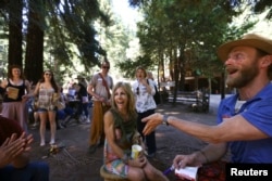 A camper smiles as a staffer announces her camp nickname at Camp Grounded in the Navarro, California, June 20, 2014.