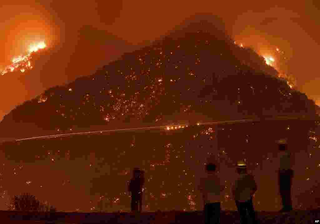 Firefighters monitor the Thomas fire as it burns through Los Padres National Forest near Ojai, California, Dec. 8, 2017.