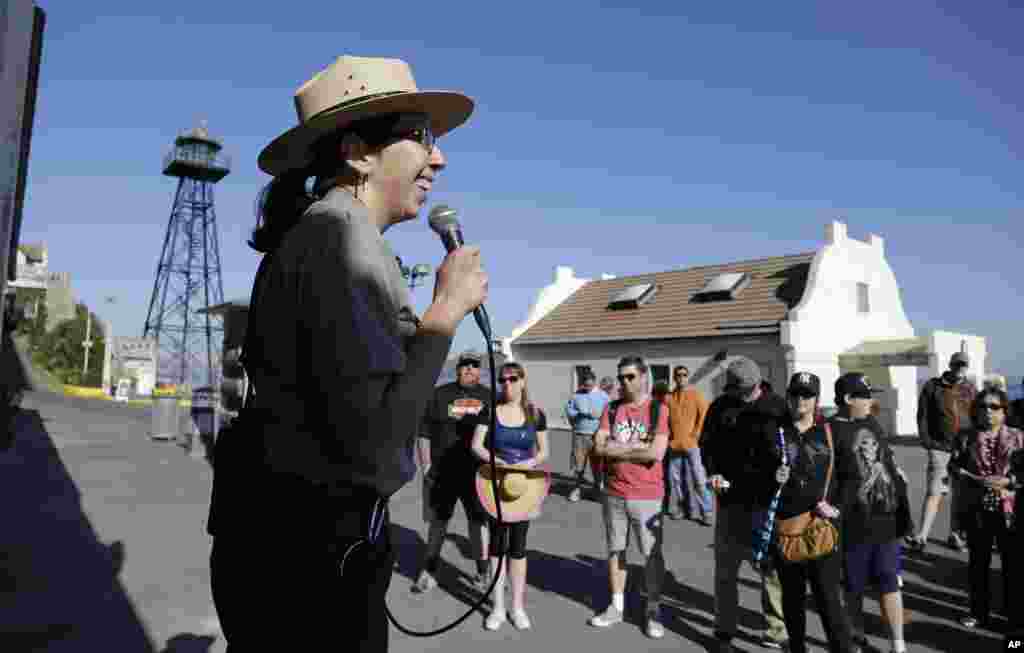 National Park Service Ranger Wendy Solis welcomes visitors to Alcatraz Island, Oct. 17, 2013, after it reopened following a partial government shutdown, in San Francisco, California. 