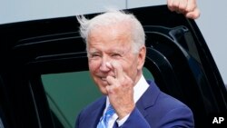 Presidenti Joe Biden bën gjestin e shpresëdhënies ndërsa pyetet nga gazetarët në Çikago për marrëveshjen për tavanin e borxhit (7 tetor 2021)