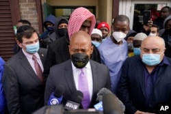 New York City Mayor Eric Adams, center, speaks to reporters after visiting the Masjid-Ur-Rahmah mosque in the Bronx borough of New York, Friday, Jan. 14, 2022.