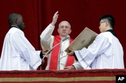 Pope Francis delivers his "Urbi et Orbi" (to the City and to the World) message from the central balcony of St. Peter's Basilica at the Vatican, Dec. 25, 2013.