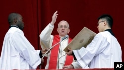 Pope Francis delivers his "Urbi et Orbi" (to the City and to the World) message from the central balcony of St. Peter's Basilica at the Vatican, Dec. 25, 2013.