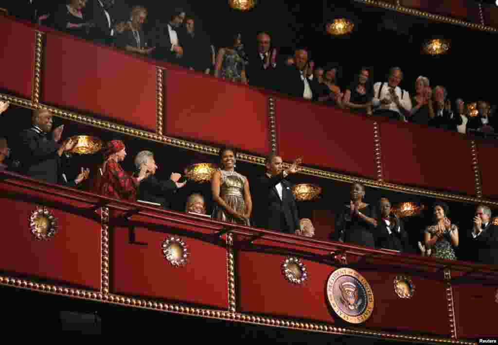 U.S. President Barack Obama and first lady Michelle Obama acknowledge the crowd on the balcony as they attend the 2012 Kennedy Center Honors at the Kennedy Center in Washington, December 2, 2012.