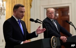 President Donald Trump, right, listens as Polish President Andrzej Duda, left, speaks during a joint news conference in the East Room of the White House in Washington, Sept. 18, 2018.