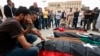FILE - Mourners gather for funeral prayers for fighters killed by warplanes of Field Marshal Khalifa Hifter's forces, April 24, 2019, in Tripoli, Libya. 