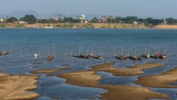 In this Wednesday, Dec. 4, 2019, photo, fishing boats are moored in Mekong River, which has turned blue instead of its usual muddy color, in Nakhon Phanom province, northeastern Thailand. (AP Photo/Chessadaporn Buasai)