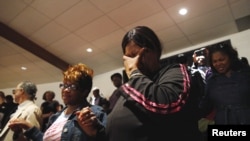 Mourners react during funeral services for 25-year old Freddie Gray, a Baltimore black man who died in police custody, at New Shiloh Baptist Church in Baltimore, Maryland, April 27, 2015.